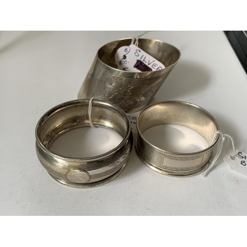 496 - TWO HALLMARKED BIRMINGHAM SILVER NAPKIN RINGS AND A FURTHER SILVER RING WITH A MAP OF CYPRUS