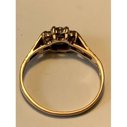 505 - A 9 CARAT GOLD RING WITH A CENTRE SAPPHIRE SURROUNDED BY CUBIC ZIRCONIAS SIZE N/O