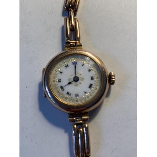 513 - A 9 CARAT GOLD WATCH WITH A DECORATIVE WHITE ENAMEL FACE AND ROMAN NUMERALS GROSS WEIGHT 20.75 GRAMS