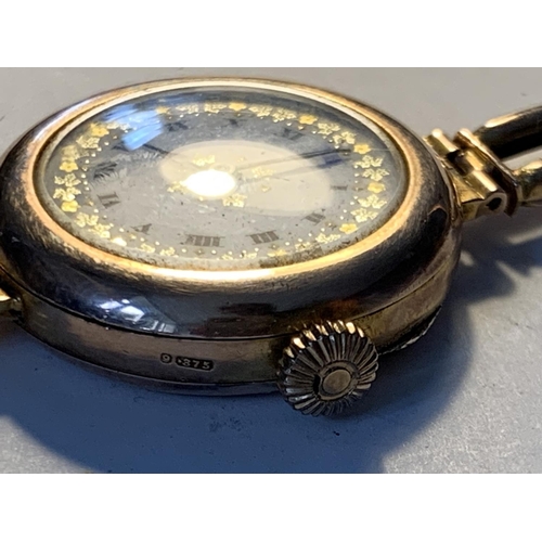 513 - A 9 CARAT GOLD WATCH WITH A DECORATIVE WHITE ENAMEL FACE AND ROMAN NUMERALS GROSS WEIGHT 20.75 GRAMS