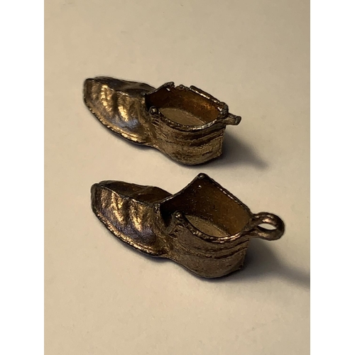 518 - A PAIR OF TESTED TO 9 CARAT GOLD BOOT CHARMS AND A PENDANT COIN HOLDER GROSS WEIGHT 8.52 GRAMS