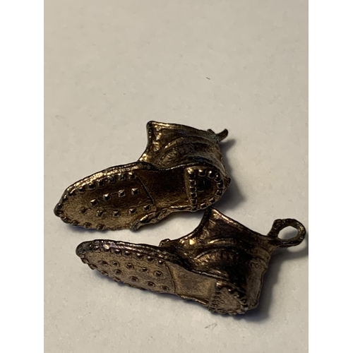 518 - A PAIR OF TESTED TO 9 CARAT GOLD BOOT CHARMS AND A PENDANT COIN HOLDER GROSS WEIGHT 8.52 GRAMS