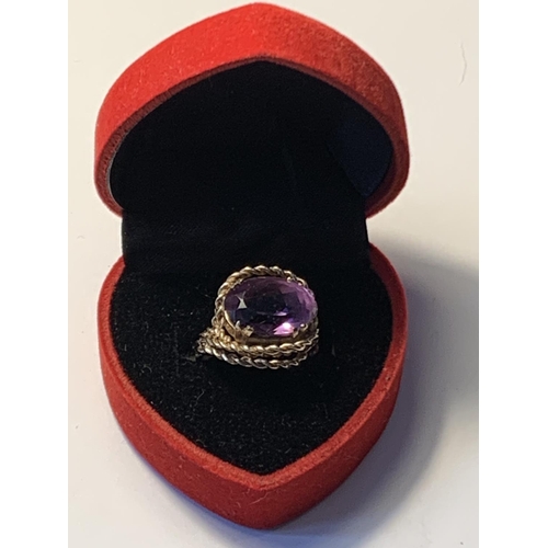 618 - A 9 CARAT GOLD RING WITH LARGE CENTRE AMETHYST SIZE L/M IN A HEART SHAPED PRESENTATION BOX