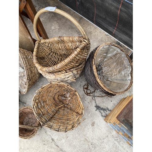 2072 - AN ASSORTMENT OF WICKER BASKETS AND A WOODEN IRONING BOARD