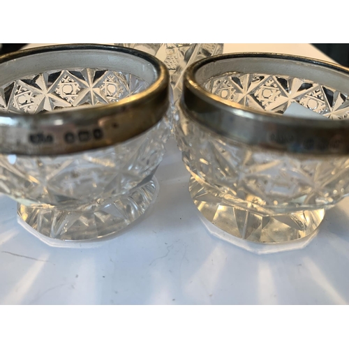 663 - THREE CUT GLASS POTS TO INCLUDE TWO HALLMARKED BIRMINGHAM 1907/08 SILVER RIMMED AND A PERFUME BOTTLE... 