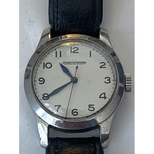 690 - A VINTAGE JAEGER LeCOUTRE WRIST WATCH WITH WHITE FACE AND BLACK LEATHER STRAP POSSIBLY MILITARY. SEE... 