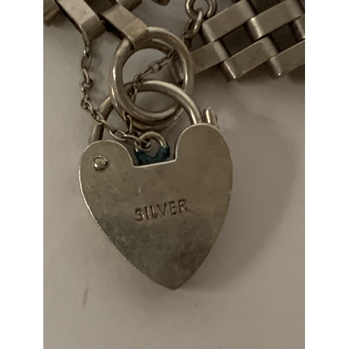 615 - A SILVER FIVE BAR GATE BRACELET WITH HEART PADLOCK FASTEN