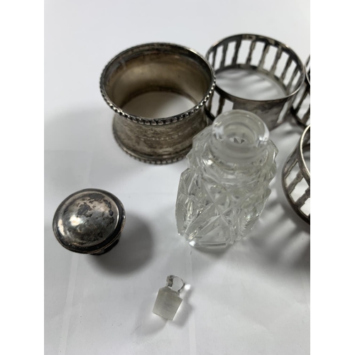 700A - FOUR SILVER NAPKIN RINGS AND A SILVER LIDDED PERFUME BOTTLE WITH STOPPER