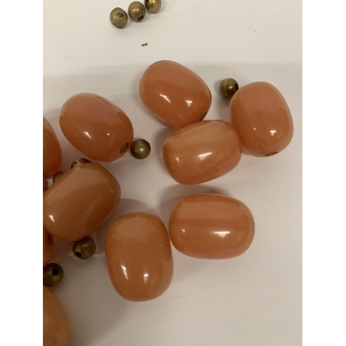 696 - FOURTEEN AMBER BEADS AND YELLOW METAL SPACER BEADS