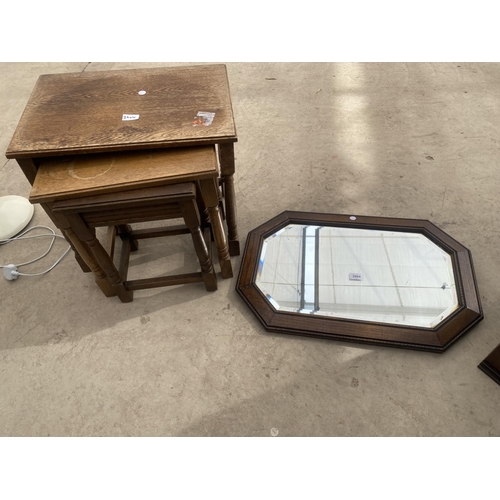 2904 - AN EARLY 20TH CENTURY OAK FRAMED WALL MIRROR AND NEST OF THREE TABLES