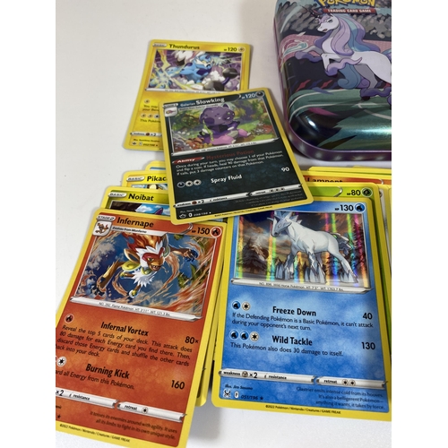 106 - A TIN OF ASSORTED POKEMON CARDS, HOLOS, RARES ETC