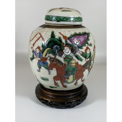 345 - A LATE 19TH/EARLY 20TH CENTURY CHINESE CRACKLE GLAZE WARRIOR DESIGN GINGER JAR ON CARVED WOODEN BASE... 