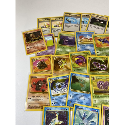 324 - A COLLECTION OF 1999 POKEMON FOSSIL SET CARDS, HOLO HITMONLEE, LAPRAS, MEWTWO PROMO ETC