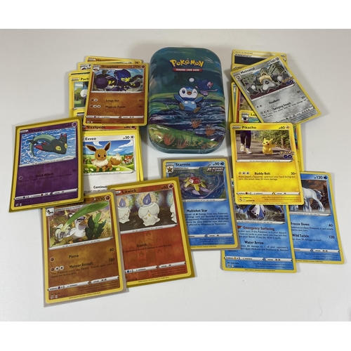 332 - A TIN OF ASSORTED POKEMON CARDS, HOLOS ETC