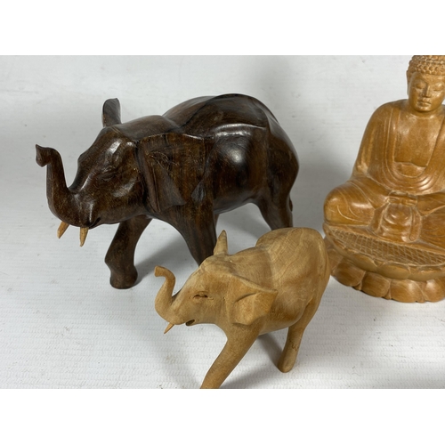 353 - A GROUP OF ORIENTAL CARVED WOODEN FIGURES, SEATED BUDDHA, TURTLES AND TWO ELEPHANTS