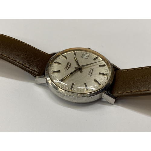 516 - A VINTAGE LONGINES CONQUEST AUTOMATIC WRIST WATCH WITH LEATHER STRAP SEEN WORKING BUT NO WARRANTY