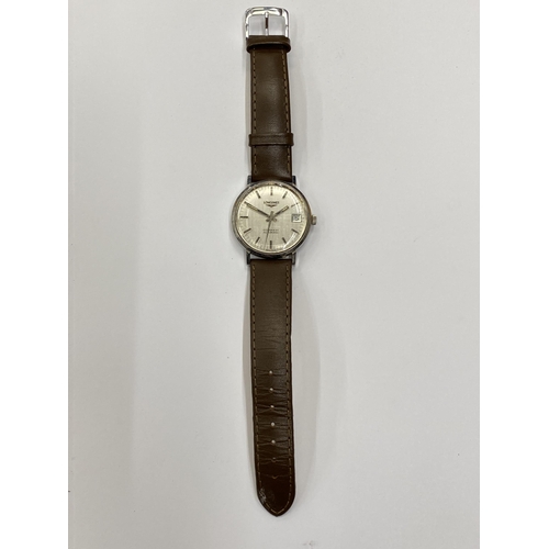 516 - A VINTAGE LONGINES CONQUEST AUTOMATIC WRIST WATCH WITH LEATHER STRAP SEEN WORKING BUT NO WARRANTY