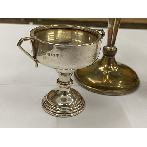 4 - A GROUP OF THREE HALLMARKED SILVER ITEMS COMPRISING A WEIGHTED CANDLESTICK, LIGHTER AND TWIN HANDLED... 