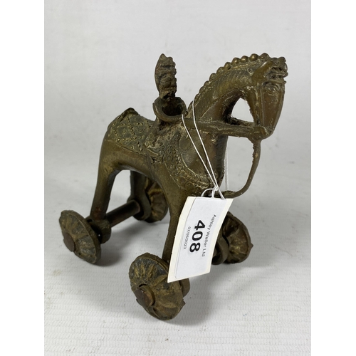 408 - AN UNUSUAL 19TH CENTURY INDIAN METAL TEMPLE TOY MODEL OF A HORSE AND RIDER, HEIGHT 12CM