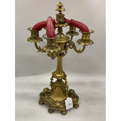 21 - A VINTAGE BRASS FIVE BRANCH CANDLEABRA WITH CHERUB DESIGN BASE, HEIGHT 47CM