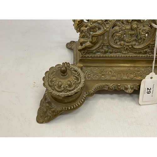 29 - A VINTAGE BRASS DESK SET INCLUDING INKWELLS AND A LETTER RACK