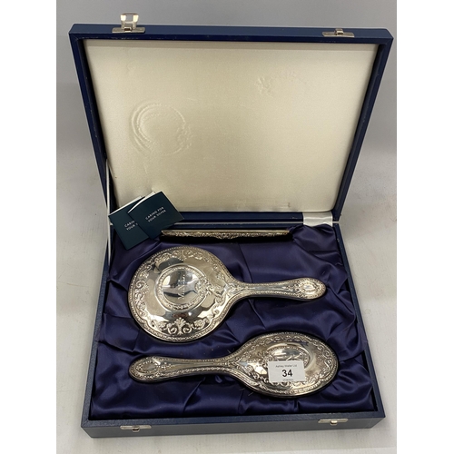 34 - A CASED HALLMARKED SILVER BACKED THREE PIECE DRESSING SET COMPRISING COMB, MIRROR AND BRUSH