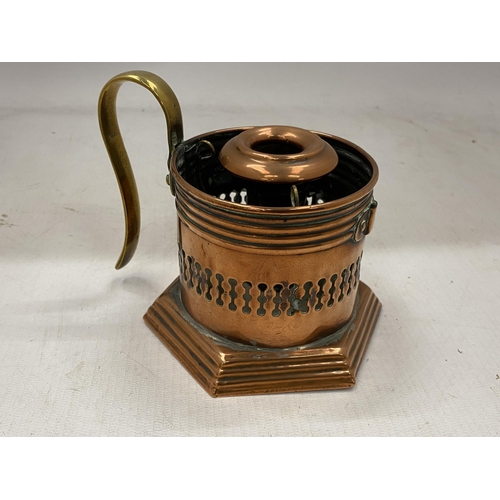 41 - AN ARTS AND CRAFTS COPPER CANDLESTICK WITH BRASS HANDLE WITH TRADE MARK STAMP TO BASE