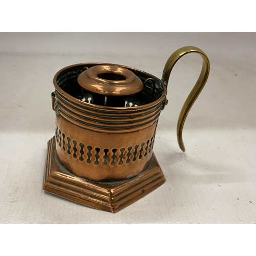 41 - AN ARTS AND CRAFTS COPPER CANDLESTICK WITH BRASS HANDLE WITH TRADE MARK STAMP TO BASE