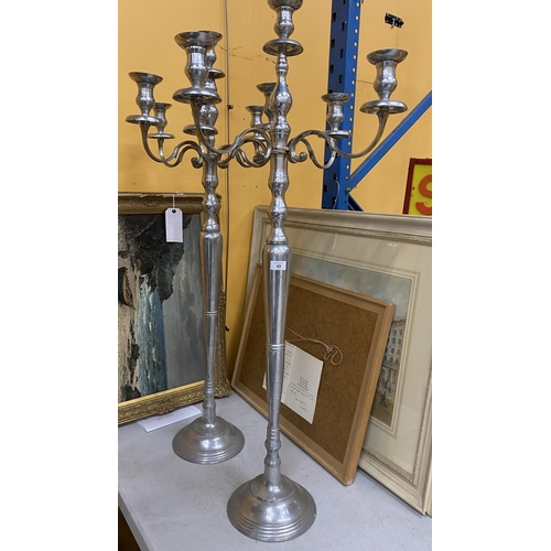 49 - A LARGE PAIR OF CHROME EFFECT FLOOR STANDING CANDLEABRA