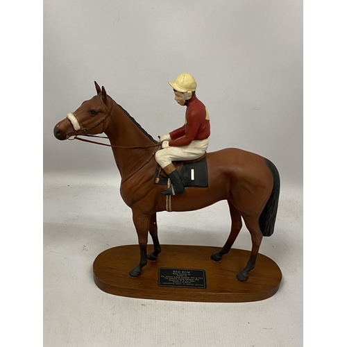 65 - A BESWICK RED RUM HORSE AND JOCKEY FIGURE ON WOODEN PLINTH BASE, HEIGHT 35CM