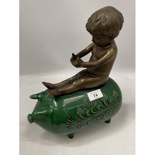 74 - A GREEN VICTORIAN CERAMIC PIG WITH BRONZE MODEL OF A BOY SEATED, HEIGHT 34CM