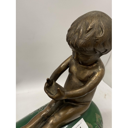 74 - A GREEN VICTORIAN CERAMIC PIG WITH BRONZE MODEL OF A BOY SEATED, HEIGHT 34CM