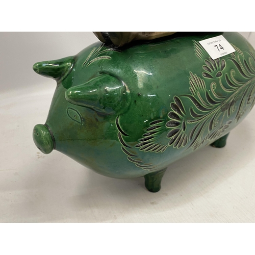 74 - A GREEN VICTORIAN CERAMIC PIG WITH BRONZE MODEL OF A BOY SEATED, HEIGHT 34CM