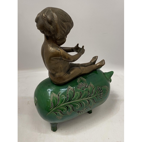 74 - A GREEN VICTORIAN CERAMIC PIG WITH BRONZE MODEL OF A BOY SEATED, HEIGHT 34CM