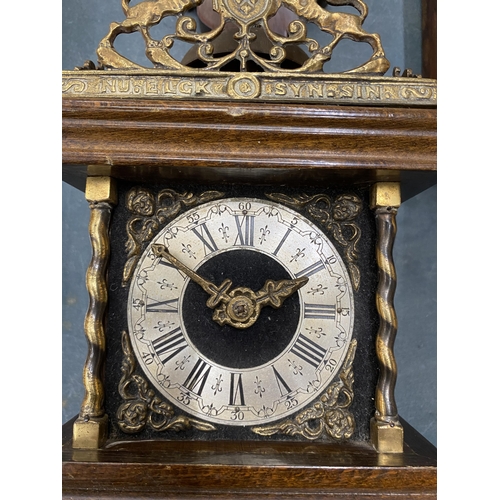 112 - A VINTAGE MAHOGANY CASED WALL CLOCK WITH BRASS DECORATION - LACKING KEY, AND WEIGHTS