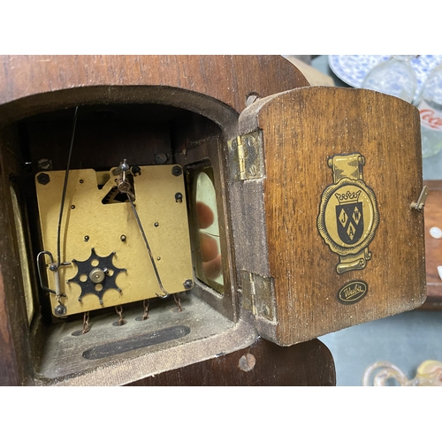 112 - A VINTAGE MAHOGANY CASED WALL CLOCK WITH BRASS DECORATION - LACKING KEY, AND WEIGHTS