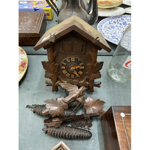 113 - A WOODEN CUCKOO CLOCK COMPLETE WITH PENDULUM AND WEIGHTS