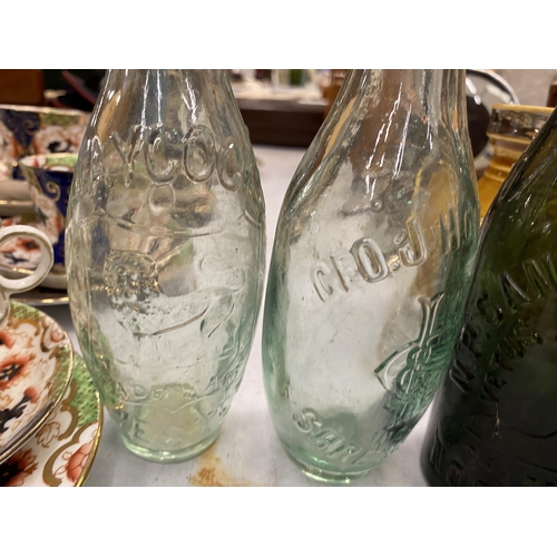 135 - FOUR VINTAGE GLASS BOTTLES