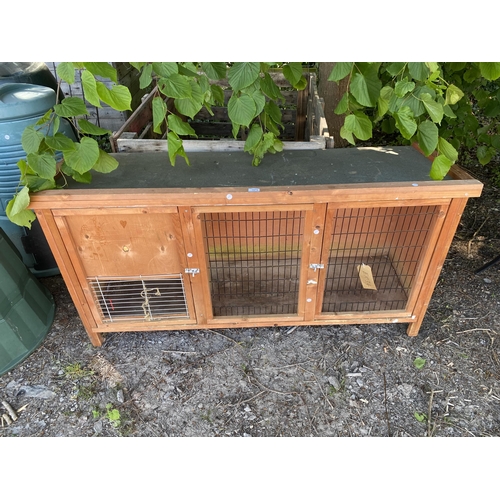 1975 - A WOODEN RABBIT HUTCH WITH MESH FRONT