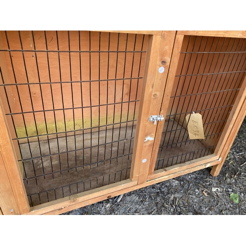 1975 - A WOODEN RABBIT HUTCH WITH MESH FRONT