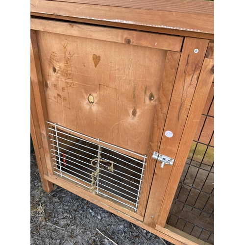 1975 - A WOODEN RABBIT HUTCH WITH MESH FRONT