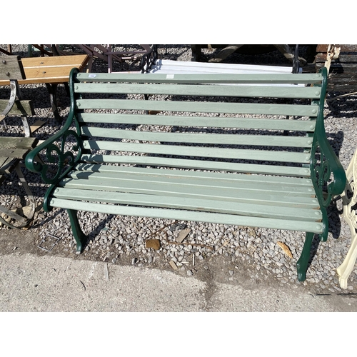 1986 - A WOODEN SLATTED GARDEN BENCH WITH CAST ENDS