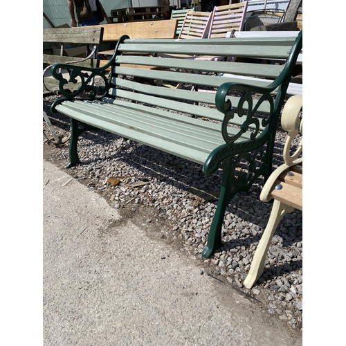 1986 - A WOODEN SLATTED GARDEN BENCH WITH CAST ENDS