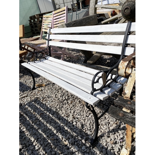 1987 - A WOODEN SLATTED GARDEN BENCH WITH CAST ENDS