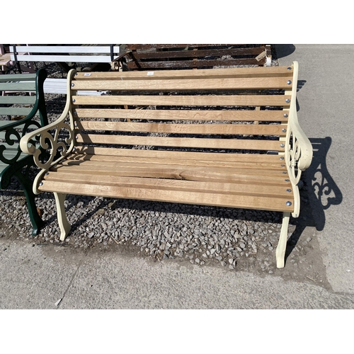 1988 - A WOODEN SLATTED GARDEN BENCH WITH CAST ENDS