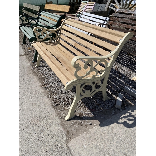 1988 - A WOODEN SLATTED GARDEN BENCH WITH CAST ENDS