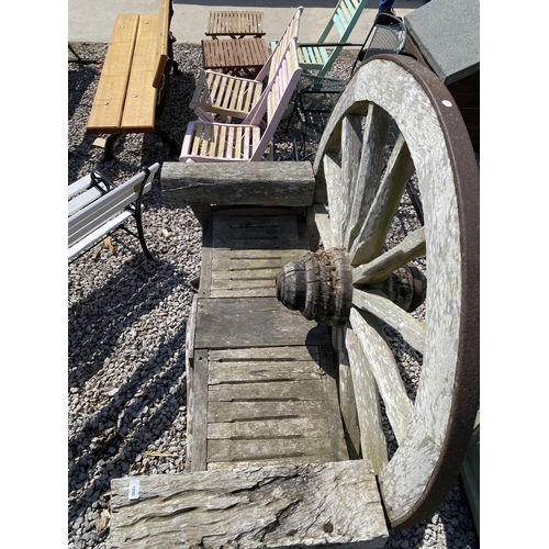 1990 - A DECORATIVE WOODEN GARDEN BENCH WITH CART WHEEL BACK