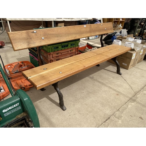 1985A - A LARGE REFURBISHED WOODEN SLATTED BENCH WITH 'KNOTTY' CAST IRON BENCH ENDS