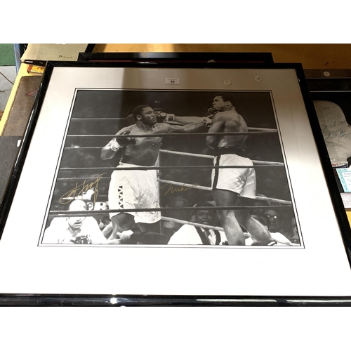 98A - A SIGNED AND FRAMED BLACK AND WHITE PHOTOGRAPH OF MUHAMMED ALI AND JOE FRAZIER WITH CERTIFICATE