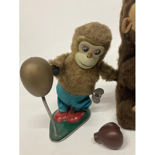 366 - A VINTAGE TINPLATE WIND UP BOXING MONKEY TOGETHER WITH A FURTHER TINPLATE MONKEY HOLDING A CONE